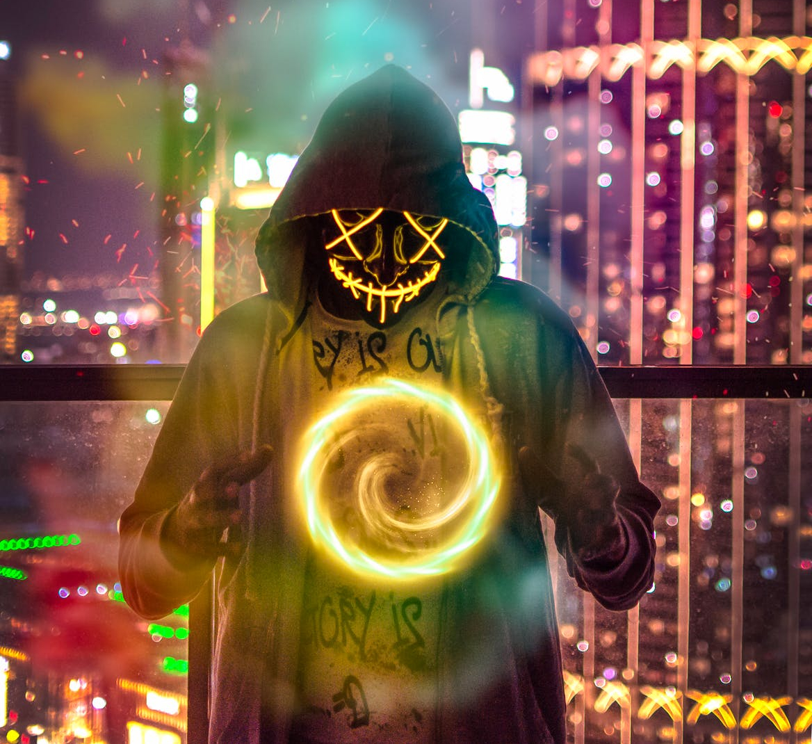 man wearing hoodie forming chakra wallpaper
